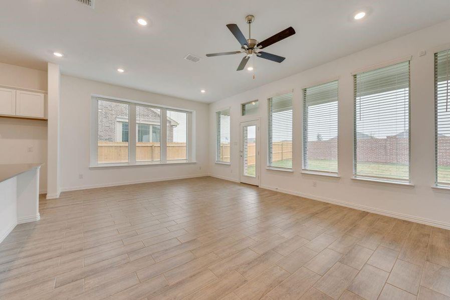 Unfurnished living room featuring light wood-type flooring and ceiling fan