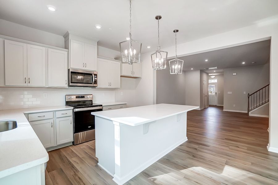 Kitchen with gathering room beyond