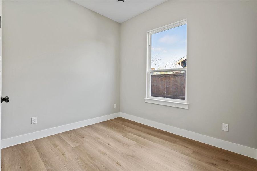 Unfurnished room featuring light wood-style floors and baseboards