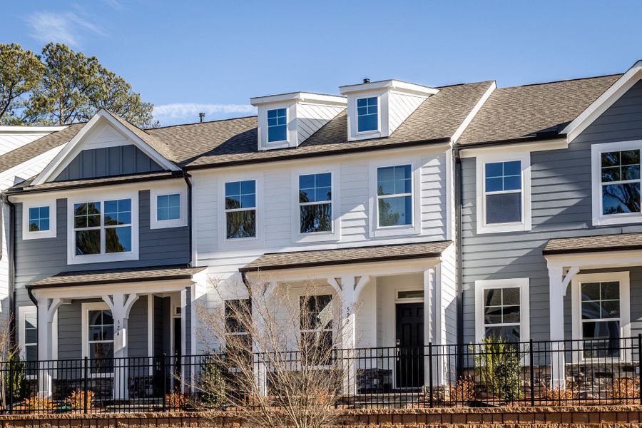 Front exterior of a new home in Enclave at Traditions Townhomes, Wake Forest, NC, highlighting curb appeal (Image 2). Front exterior of a new home in Enclave at Traditions Townhomes, Wake Forest, NC, highlighting curb appeal (Image 2).