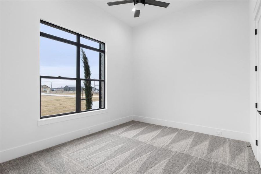 Unfurnished room featuring ceiling fan and light colored carpet