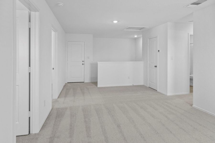 Spare room with light carpet, attic access, and recessed lighting