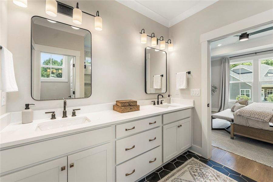 This primary bathroom features a dual vanity, prov