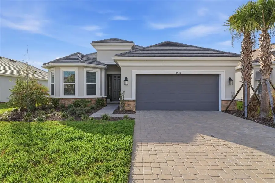 Front exterior of a new home in , Wesley Chapel, FL, highlighting curb appeal (Image 1). Front exterior of a new home in , Wesley Chapel, FL, highlighting curb appeal (Image 1).