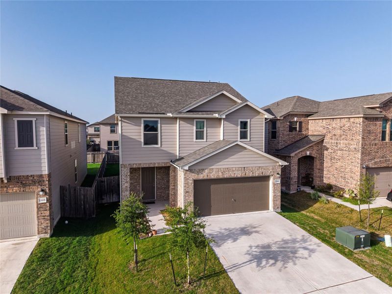 A newly constructed residence features a spacious driveway and attached garage. A newly constructed residence features a spacious driveway and attached garage.