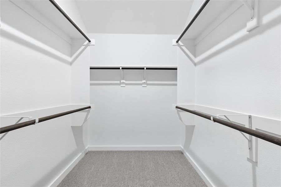 Walk in closet featuring light colored carpet Walk in closet featuring light colored carpet