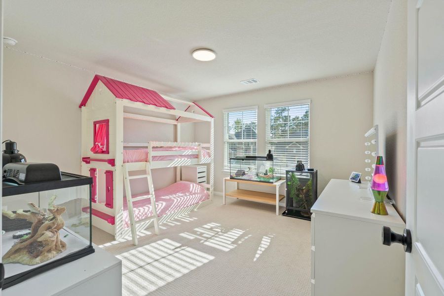 This bright bedroom features ample natural light from large windows, upgraded carpeting, door hinges and door knobs. This bright bedroom features ample natural light from large windows, upgraded carpeting, door hinges and door knobs.