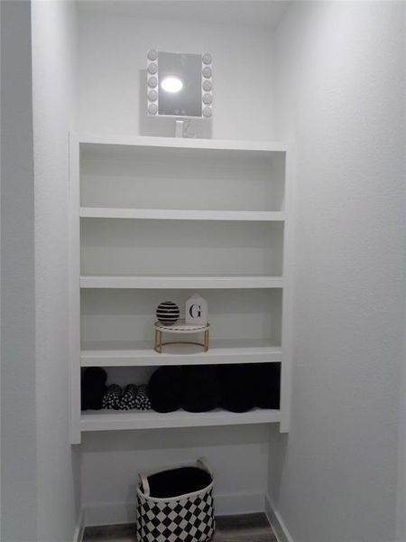 Extra storage shelves in addition to a linen closet