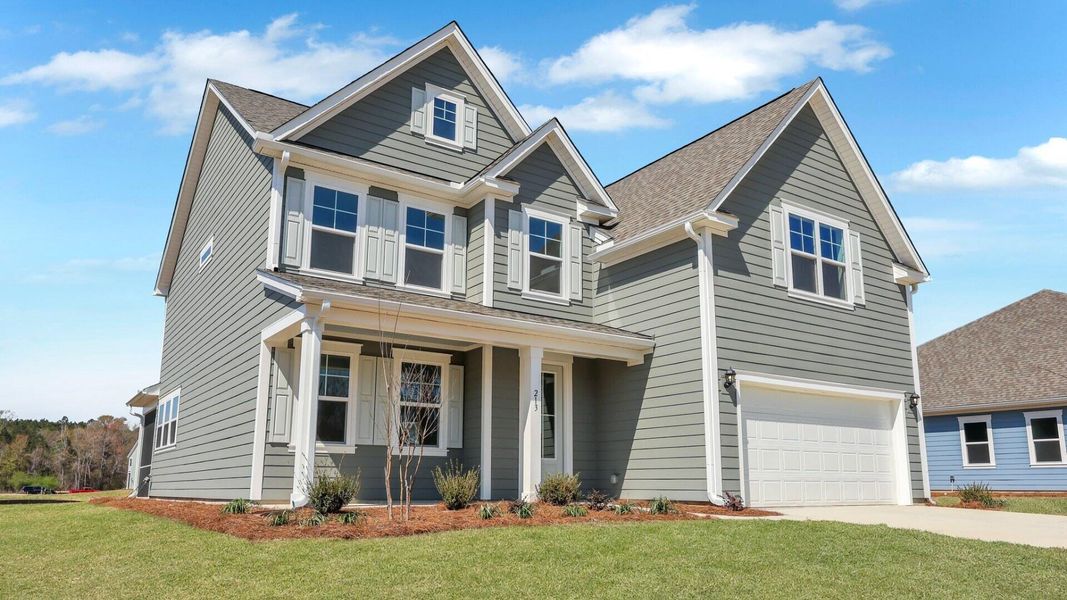 Front exterior of a new home in Berkeley Bay, Ridgeville, SC, highlighting curb appeal (Image 1).