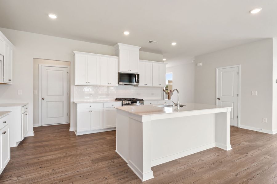 A kitchen with white cabinets. A kitchen with white cabinets.
