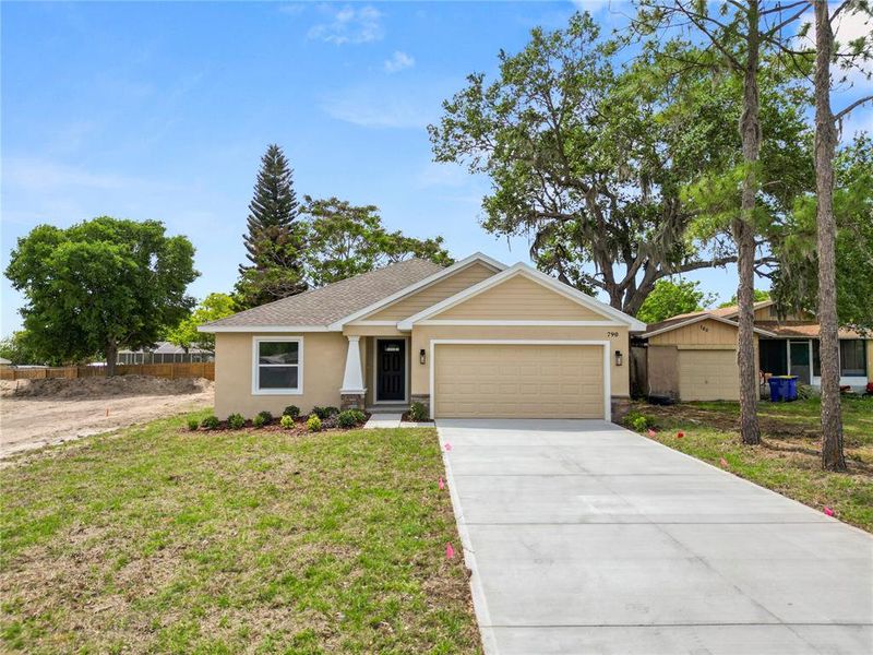 Front exterior of a new home in , Eagle Lake, FL, highlighting curb appeal (Image 24).