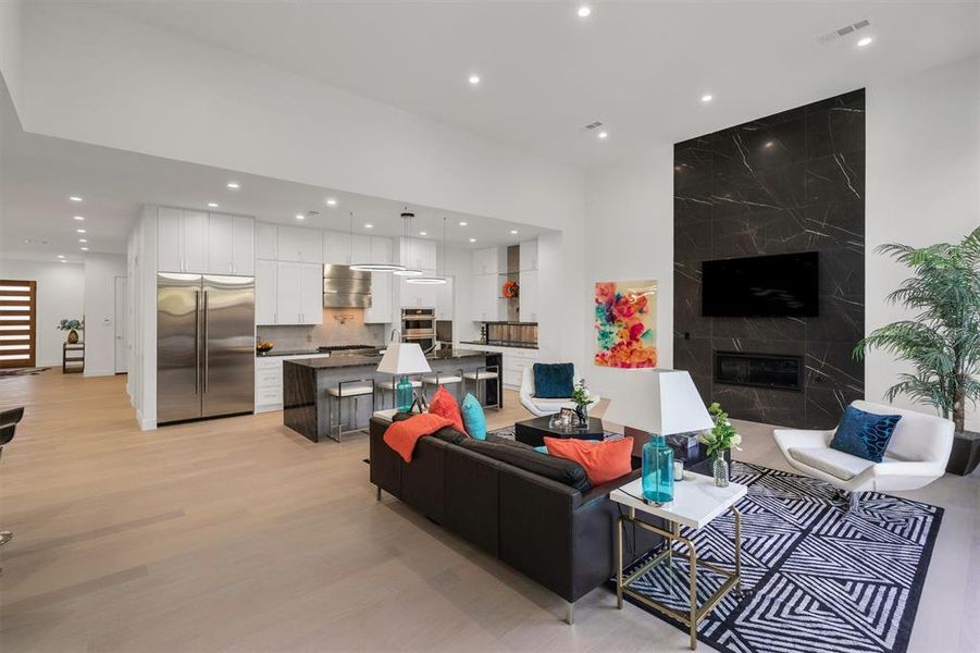 Living room featuring light hardwood / wood-style floors and a premium fireplace