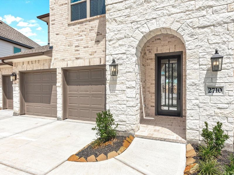 Front exterior of a new home in Lago Mar - 60', Texas City, TX, highlighting curb appeal (Image 18). Front exterior of a new home in Lago Mar - 60', Texas City, TX, highlighting curb appeal (Image 18).