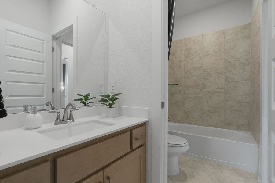 Representative furnished interior of a home built from the Madison by Chesmar Homes in Lakes of Cane Island, Katy (Image 22).