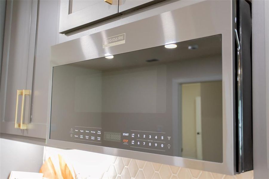 Kitchen view of stainless steel microwave and light countertops Kitchen view of stainless steel microwave and light countertops