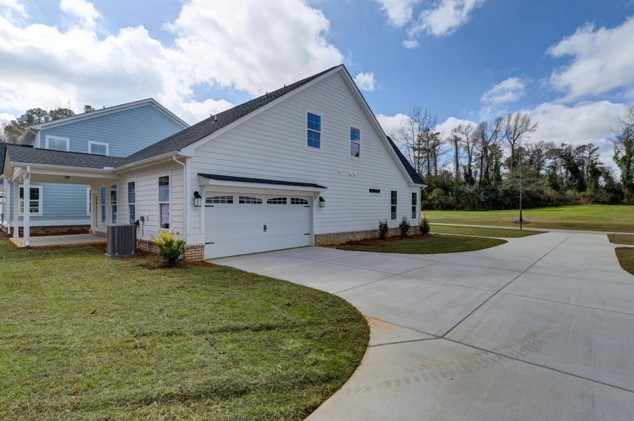 Front exterior of a new home in Clubside Reserve at Summerlake, Lexington, SC, highlighting curb appeal (Image 27). Front exterior of a new home in Clubside Reserve at Summerlake, Lexington, SC, highlighting curb appeal (Image 27).