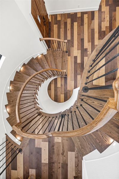 Striking spiral staircase crafted with warm wood treads and iron detailing, providing a beautiful architectural transition from the downstairs creative space to the second floor. Striking spiral staircase crafted with warm wood treads and iron detailing, providing a beautiful architectural transition from the downstairs creative space to the second floor.