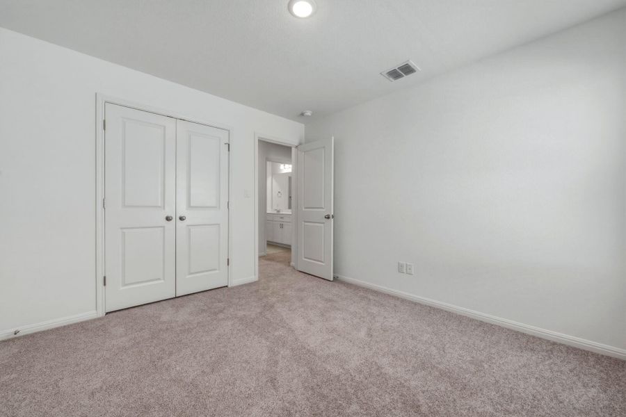 Unfurnished bedroom featuring carpet and a closet