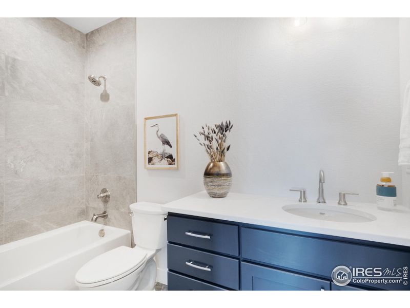 The full guest bath, which also features full-height tile