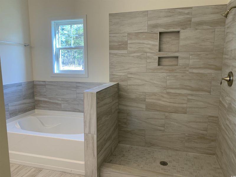 Bathroom with a bath and a stall shower