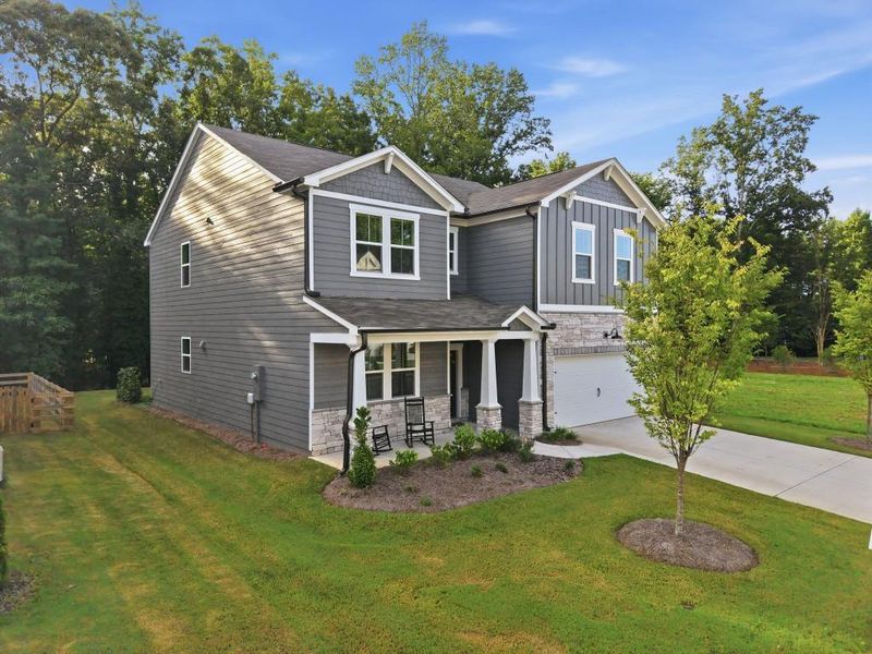Front exterior of a new home in Cambridge at Steels Bridge, Canton, GA, highlighting curb appeal (Image 23).