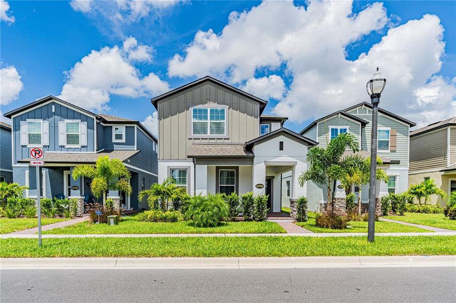 Front exterior of a new home in Encore at Ovation, Winter Garden, FL, highlighting curb appeal (Image 22).