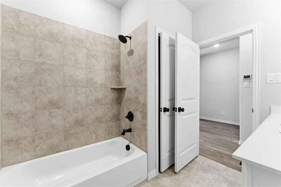 Bathroom featuring vanity and  shower combination