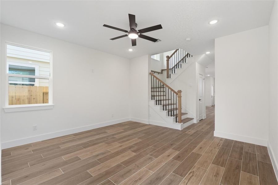 The main living area features durable wood-look tile flooring, recessed lighting, and a sleek ceiling fan, creating a bright and airy environment perfect for everyday living. Designed with flow and functionality in mind, this space seamlessly connects to the kitchen and dining areas, making it equally suited for relaxing nights at home or hosting friends! The main living area features durable wood-look tile flooring, recessed lighting, and a sleek ceiling fan, creating a bright and airy environment perfect for everyday living. Designed with flow and functionality in mind, this space seamlessly connects to the kitchen and dining areas, making it equally suited for relaxing nights at home or hosting friends!