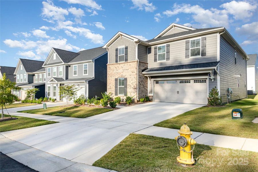 Front exterior of a new home in Cannon Run, Concord, NC, highlighting curb appeal (Image 1).