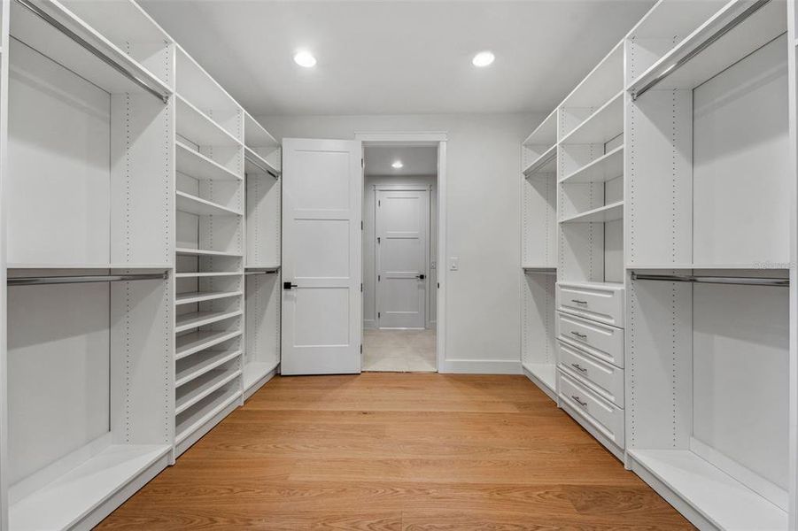 Owners closet with entry to laundry room too