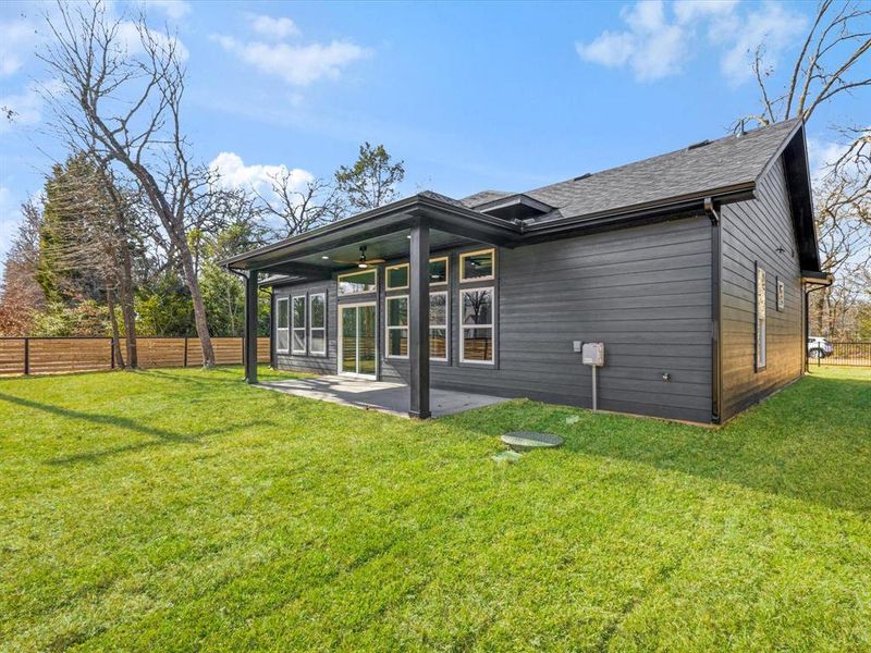 Back of house featuring a fenced backyard, a patio, and a ceiling fan