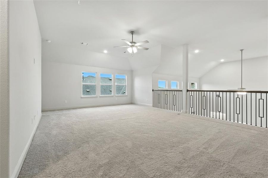 Carpeted spare room featuring a ceiling fan, lofted ceiling, and recessed lighting