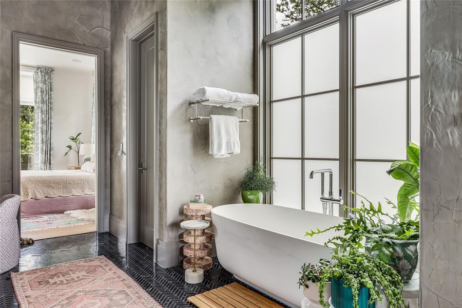 Indulge in a rejuvenating bath with a deep soaking tub positioned beside a privacy window.