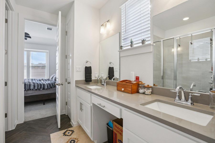 Full bathroom featuring double vanity, ensuite bath, and a shower stall Full bathroom featuring double vanity, ensuite bath, and a shower stall