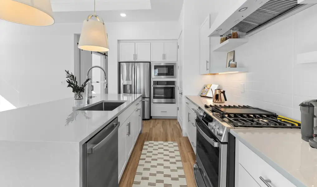 Kitchen with waterfall island and stainless steel appliances Kitchen with waterfall island and stainless steel appliances