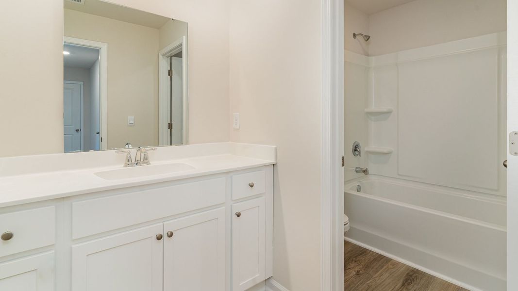 Representative furnished interior of a home built from the WREN by D.R. Horton in Saltgrass Landing, Winnabow (Image 13).