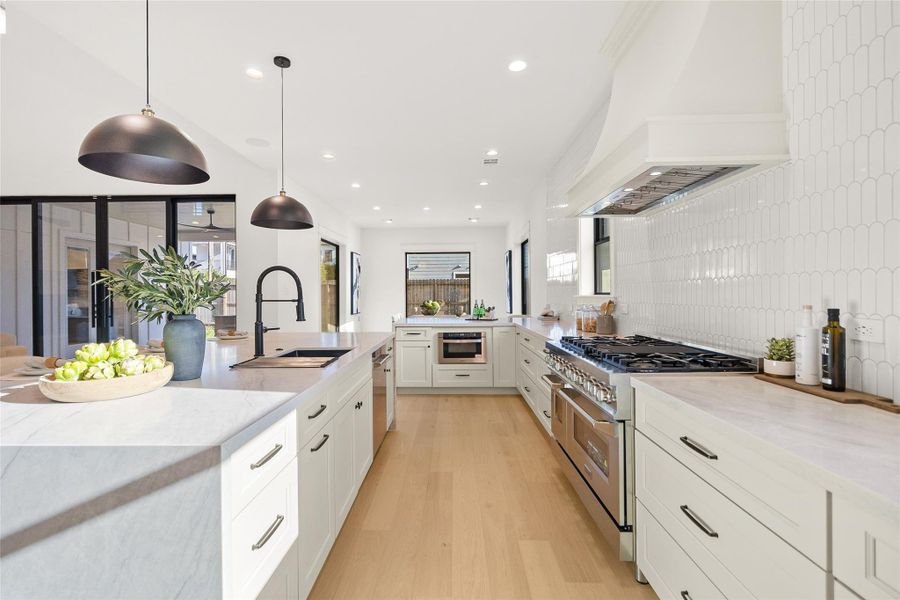 Your dream kitchen is designed to impress with stunning Taj Mahal quartzite counters, a double waterfall island, professional-grade ZLINE appliances, custom cabinetry, and elegant finishes throughout.