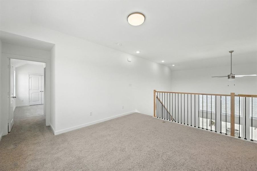 Carpeted spare room with recessed lighting and a ceiling fan