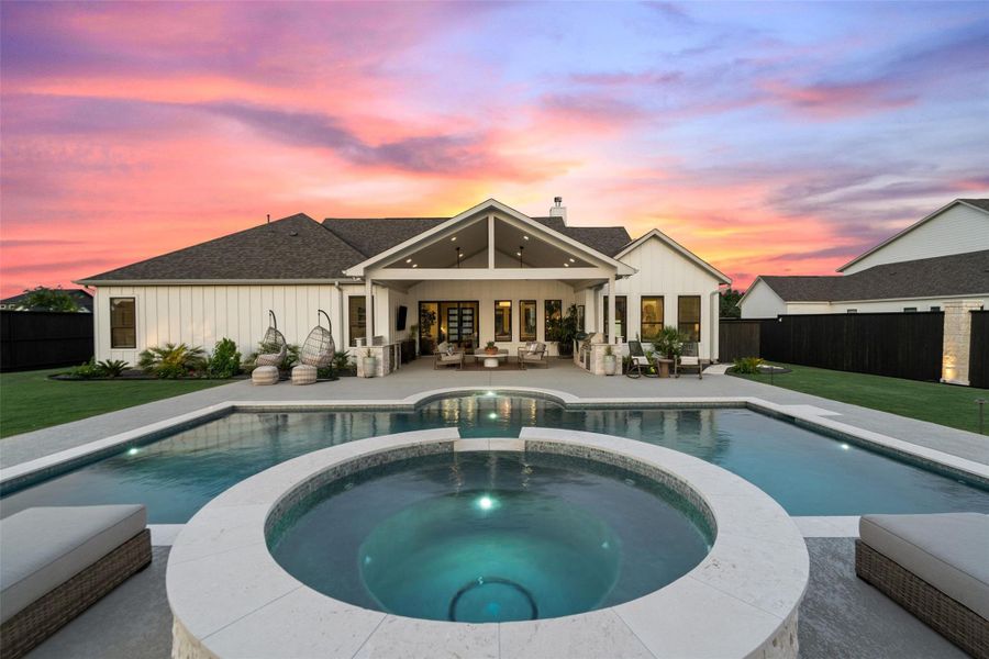 An inviting backyard oasis offers a sparkling pool and spa, perfect for outdoor entertaining under vibrant skies. An inviting backyard oasis offers a sparkling pool and spa, perfect for outdoor entertaining under vibrant skies.