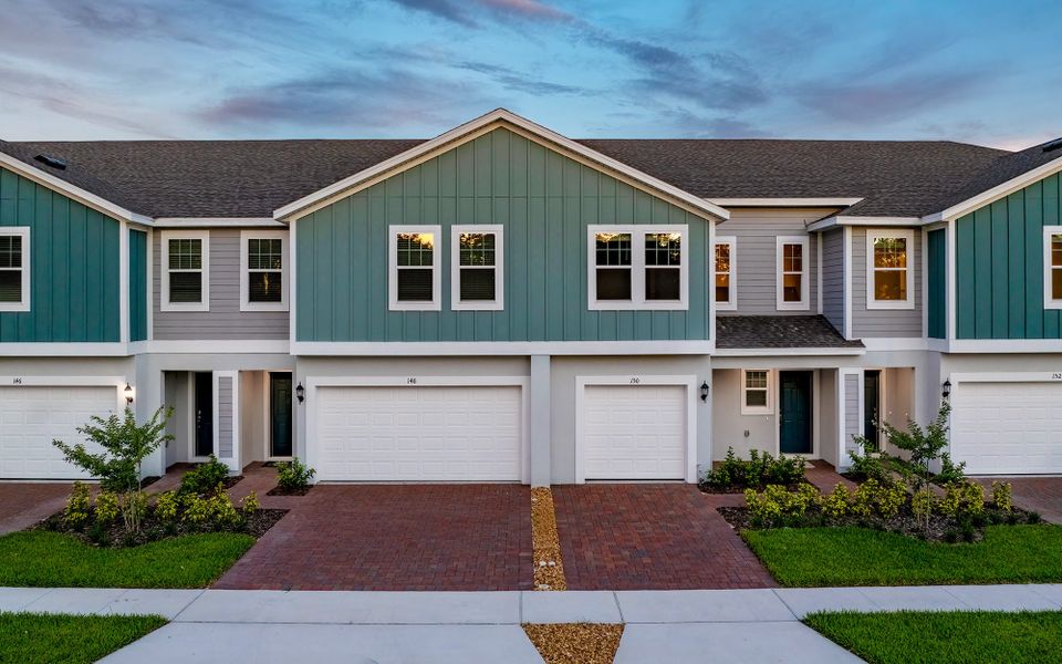 Front exterior of a new home in Blue Springs Reserve Townhomes, Groveland, FL, highlighting curb appeal (Image 9).