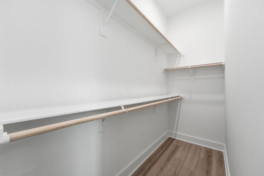Finally, a closet that keeps up with your life. This spacious primary walk-in with double hanging rods, upper shelving, and LVP flooring gives you all the room you need to stay organized and feel put-together every morning. Finally, a closet that keeps up with your life. This spacious primary walk-in with double hanging rods, upper shelving, and LVP flooring gives you all the room you need to stay organized and feel put-together every morning.
