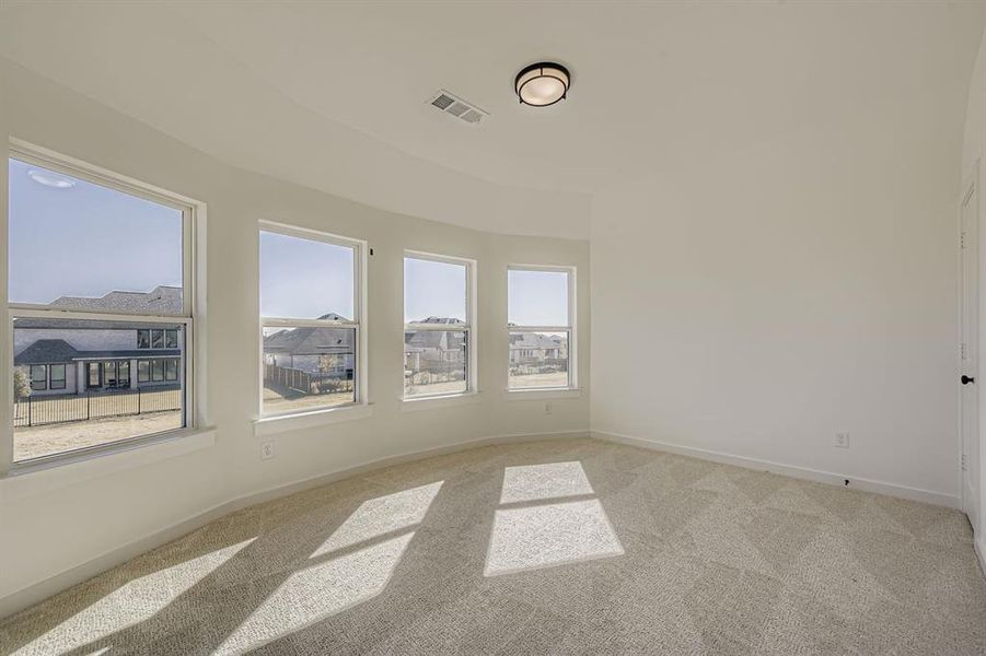 Spare room with light carpet and baseboards
