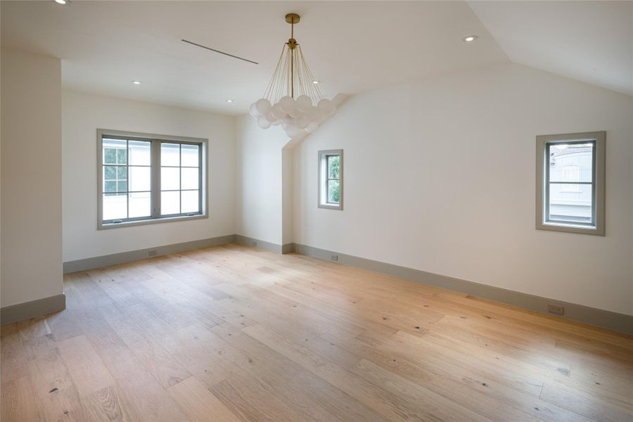 Another look at the primary suite, where the architecture does the talking. Soaring ceilings, abundant natural light, and a warm palette give the room an understated sense of scale.