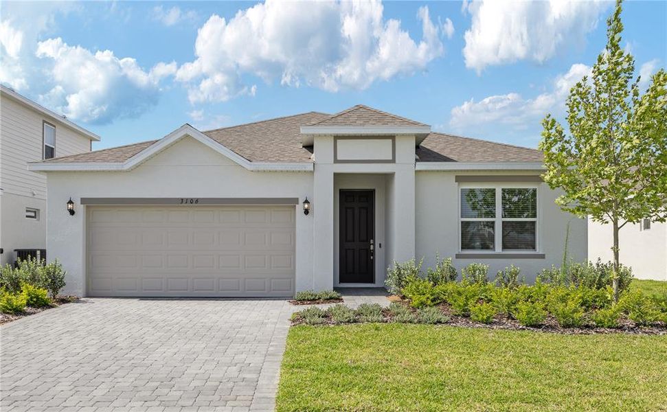 Front exterior of a new home in Highfield at Twisted Oaks, Wildwood, FL, highlighting curb appeal (Image 1).