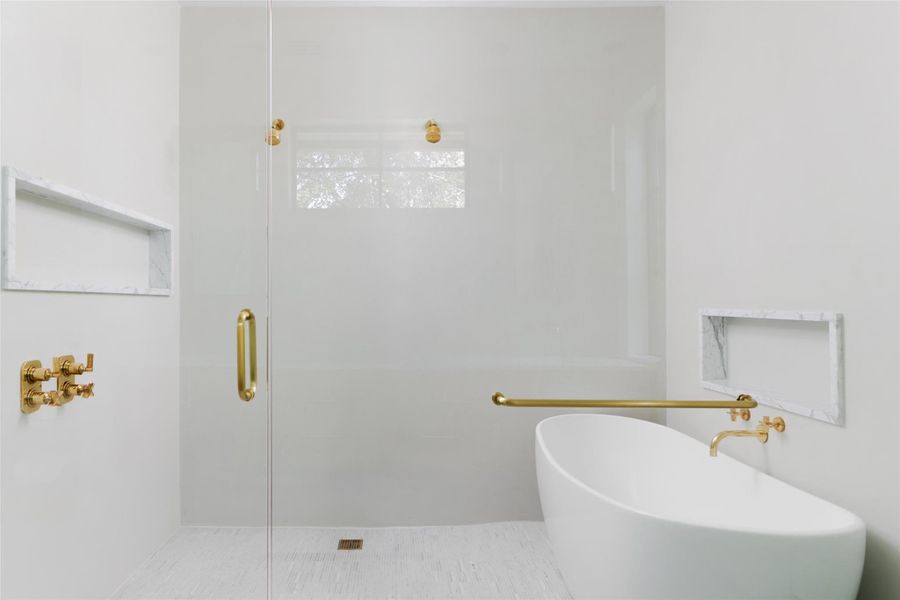 The oversized walk-in shower and soaking tub offer a spa-like retreat, combining luxury, space, and tranquility for the ultimate in relaxation.