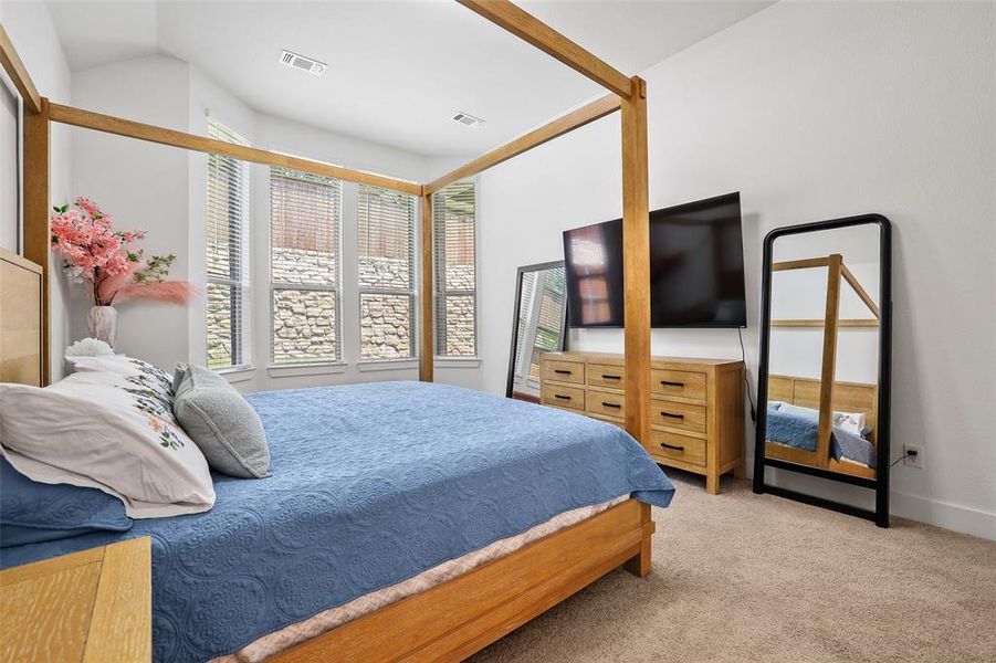 Large bay windows fill the primary bedroom with light Large bay windows fill the primary bedroom with light