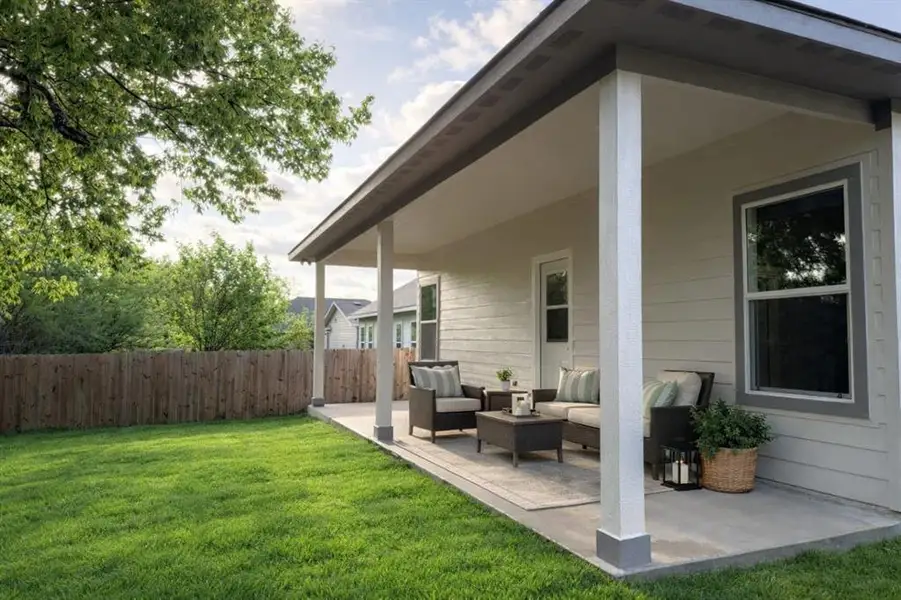 Virtual staging for illustration purposes only. with a well-maintained lawn and a wooden fence