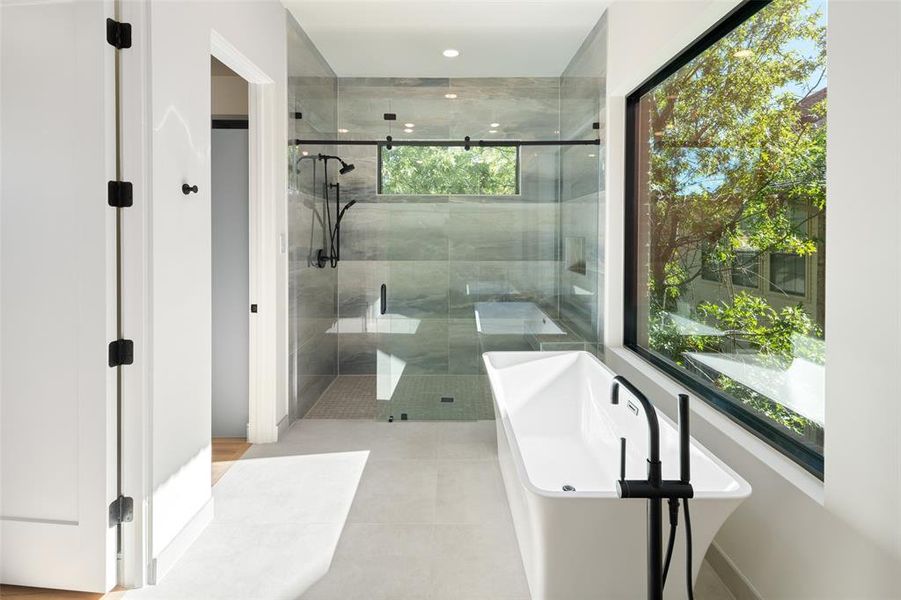 Bathroom with separate shower and tub and tile patterned flooring