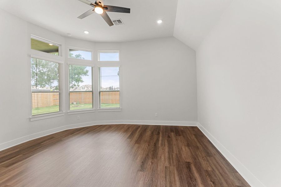 Unfurnished room with a ceiling fan, dark wood finished floors, baseboards, recessed lighting, and vaulted ceiling Unfurnished room with a ceiling fan, dark wood finished floors, baseboards, recessed lighting, and vaulted ceiling