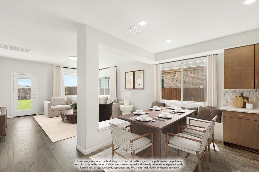 Open-plan dining area with wood table and chairs, adjoining living room with hardwood floors and backyard view